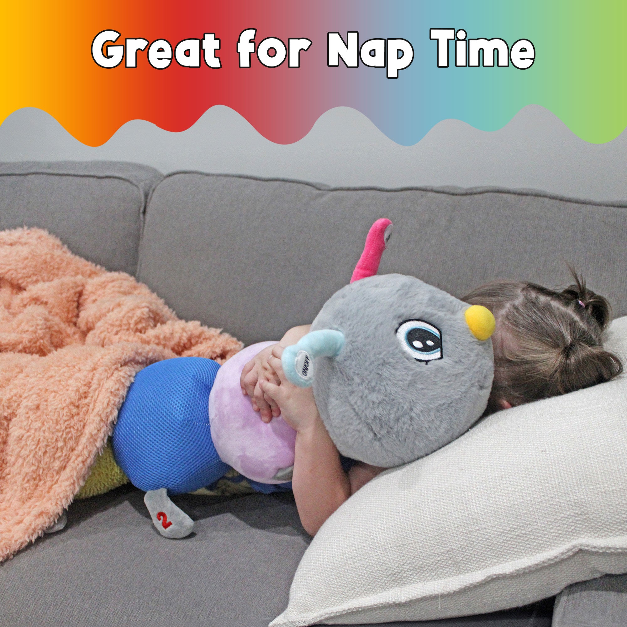 Child resting on a couch while hugging the soft CuddleBug vibrating sensory caterpillar