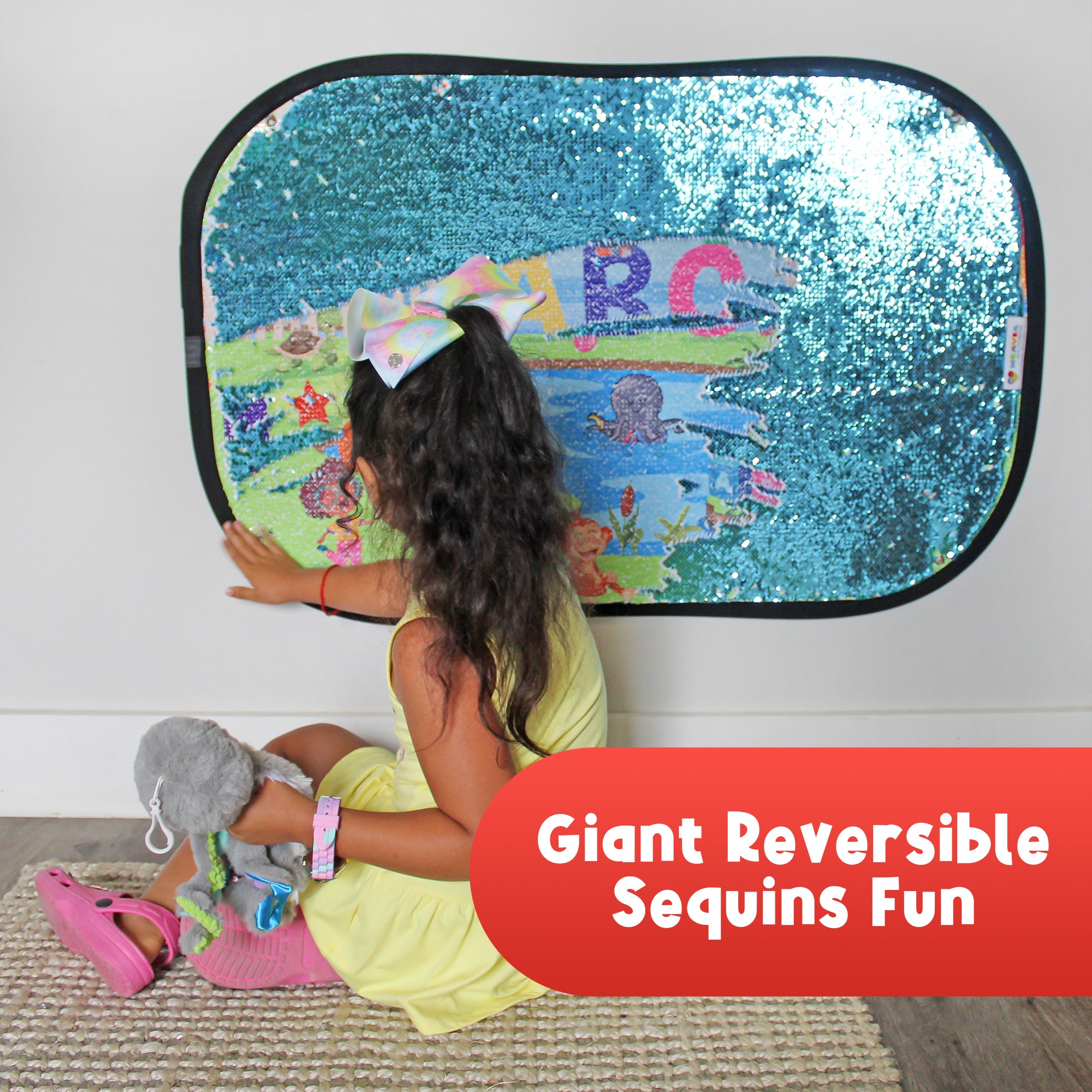 Child playing with the reversible sequin surface of the Giant Sequins Learning Discovery Toy