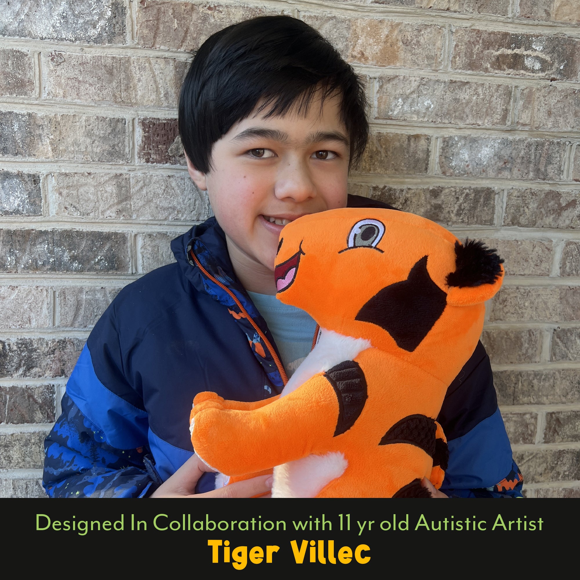 Tiger Villec holding TAT the Autistic Tiger plush designed in collaboration with the young autistic artist