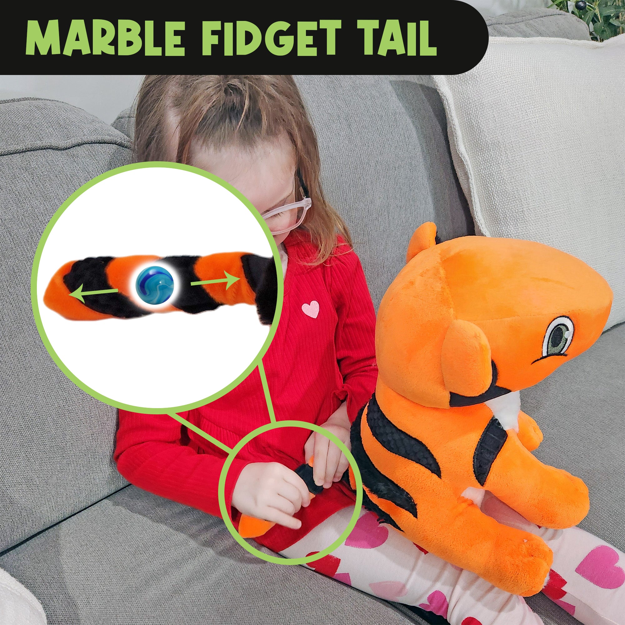 Child exploring the marble fidget inside the striped tail of TAT the Autistic Tiger sensory plush